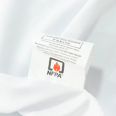 Fire-retardant fabric label on white textile close-up