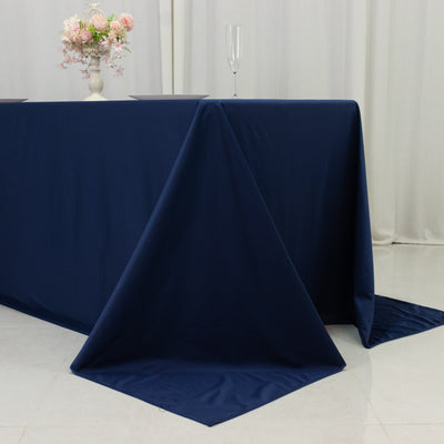 Navy blue tablecloth draped elegantly on a table with floral centerpiece.