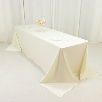 Elegant cream tablecloth draped over a table in a minimalist setting.