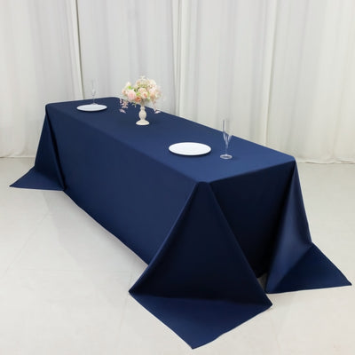 Navy blue tablecloth draped on a table with floral centerpiece and tableware