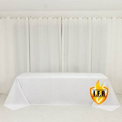 White table covered with a tablecloth in a studio setting