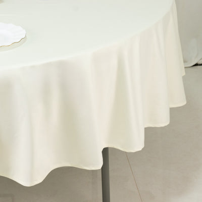 Round cream tablecloth draped elegantly over a table.