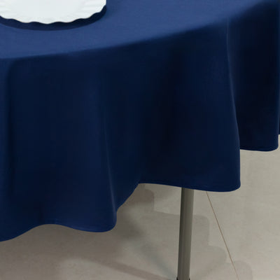 Navy blue tablecloth draped over a round table.