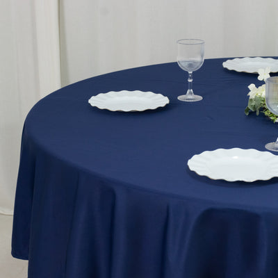 Navy round tablecloth on banquet table with place settings