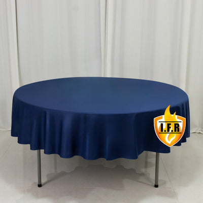 Round navy tablecloth on a round table with a smooth finish. 