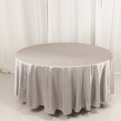 Round silver tablecloth with elegant draping.
