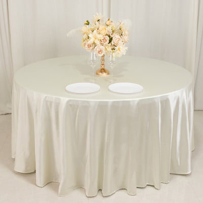 Elegant round table set with floral centerpiece and white plates.