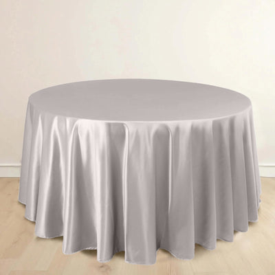 Round table covered with a soft grey tablecloth.