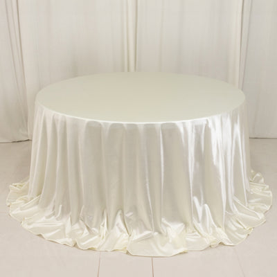 Round table with elegant satin white tablecloth