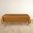 Gold tablecloth on a table with a plain backdrop