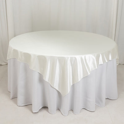 Round table with elegant white satin tablecloth