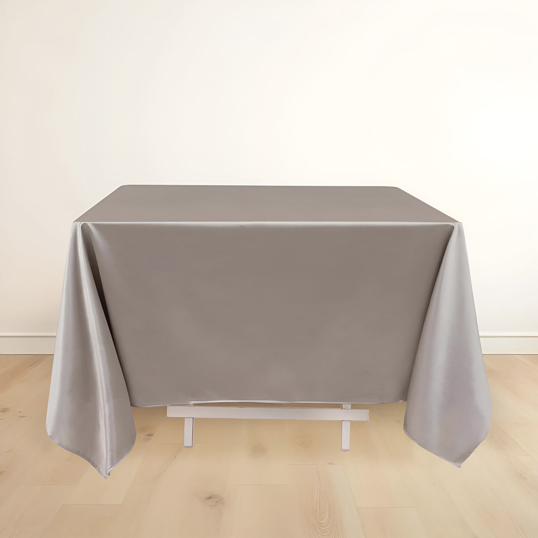 Gray tablecloth draped over a table in a studio setting