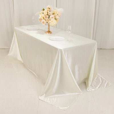 Elegant white tablecloth with floral centerpiece and wine glasses.