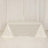 White table draped with a smooth fabric in a studio setting.