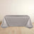 Gray tablecloth draped over a table against a plain backdrop