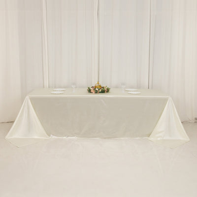 Elegant white tablecloth draped over a table, adorned with floral centerpiece.