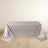 Silver tablecloth draped over a table on a light wooden floor.
