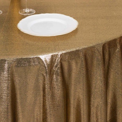 Gold tablecloth with shimmering texture and elegant plate setting.