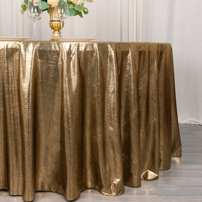 Gold shimmering tablecloth draping elegantly over a round table.