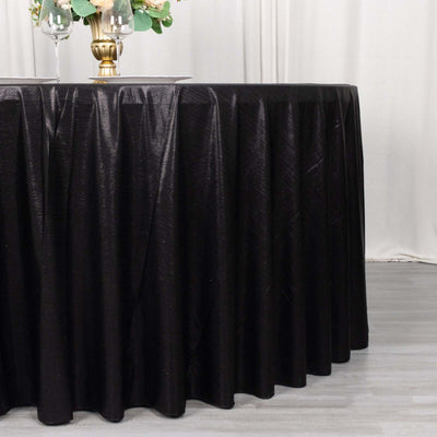Black tablecloth draping elegantly over a round table in a staged setting.