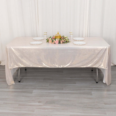 Elegant table setting with gold accents and floral centerpiece.