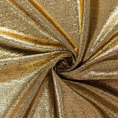 Shimmering gold sequin fabric with intricate texture and shine.