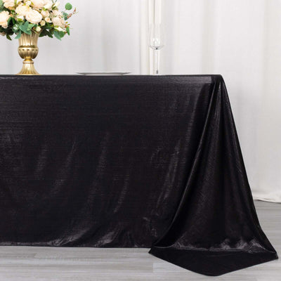 Black tablecloth draped elegantly on a table with floral centerpiece.