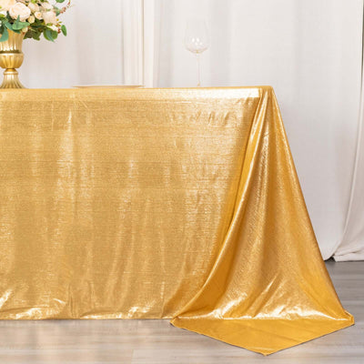 Gold tablecloth draping elegantly over a table in a styled setting.