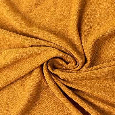 Textured mustard fabric in a swirl pattern.