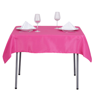Pink tablecloth set on a table with glasses and napkins