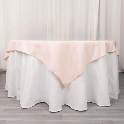 Pink tablecloth draped elegantly over a round white table.