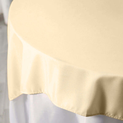 Beige round tablecloth draping elegantly over a white table.