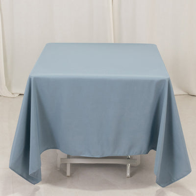 Blue tablecloth draped over a table on a plain background.
