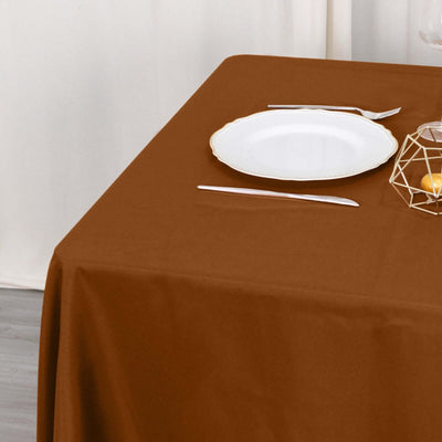 Brown tablecloth with a white plate and modern decor on a dining table.
