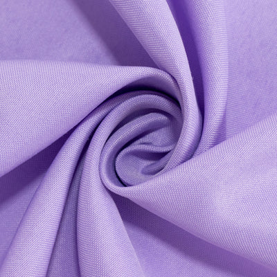 Purple textured fabric in a spiral fold, showcasing its softness and color.