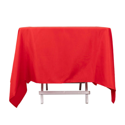 Red tablecloth draped over a table, showcasing vibrant color and texture.