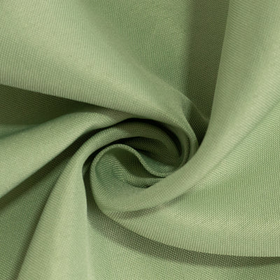 Green fabric with a textured finish, elegantly folded and twisted.
