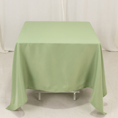 Square green tablecloth on a plain backdrop.