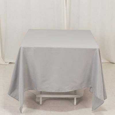 Gray tablecloth draped over a table in a studio setting
