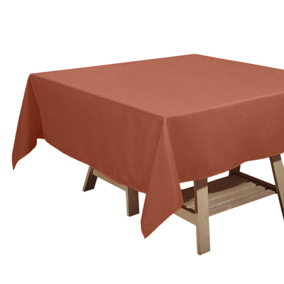Rustic terracotta tablecloth draped over a wooden table
