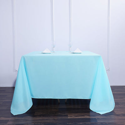 Light blue tablecloth draped over a table, styled for an elegant dining setup.
