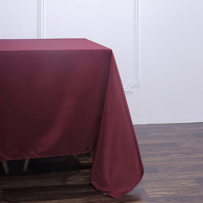 Burgundy tablecloth draped elegantly over a table edge