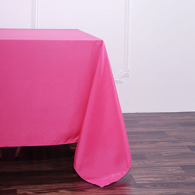 Bright pink tablecloth draping elegantly over a wooden table.