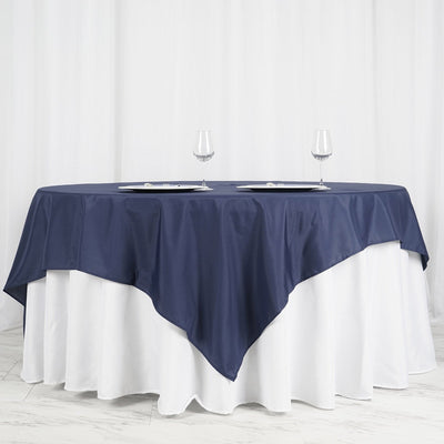 Navy tablecloth draped elegantly over a white table with wine glasses