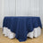 Round table with navy blue overlay and white floor-length tablecloth