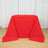Red tablecloth draped over a rectangular table in a bright studio room
