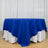 Blue tablecloth over a round table with white drape backdrop