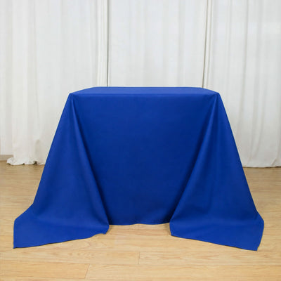 Blue tablecloth draped over a rectangular table in a studio setting