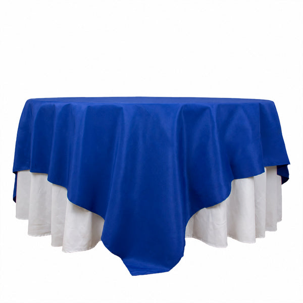 Blue and white tablecloth draped over a round table on a white background