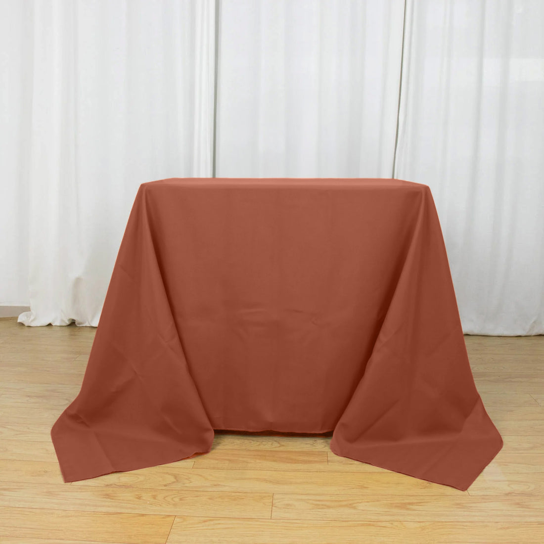 Brown tablecloth draped over a table in a studio setting.